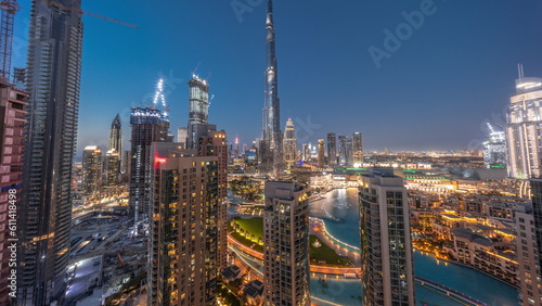 Panorama of Dubai Downtown cityscape with tallest skyscrapers around aerial day to night timelapse.