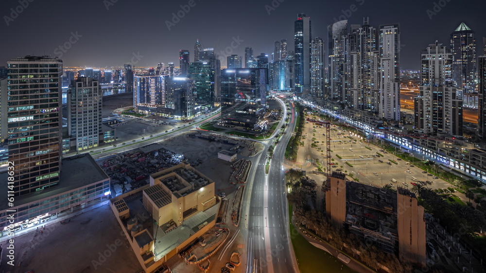 Obraz premium Panorama showing Bay Avenue with modern towers residential development in Business Bay aerial night timelapse, Dubai