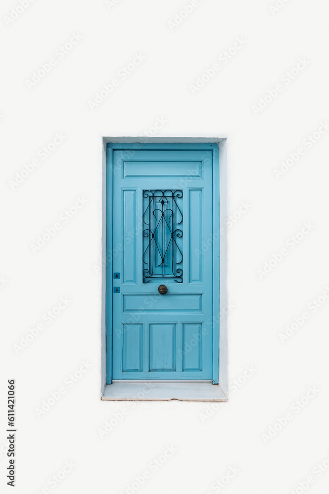 Front view of a light blue door with iron knob and central window protected with wrought iron on white isolated background. Front view of a light blue door with iron knob and central window protected with wrought iron on white isolated background.