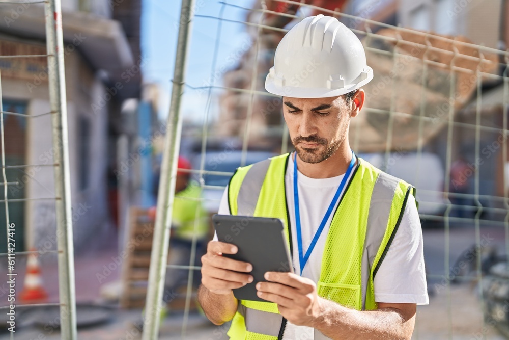 Young hispanic man architect using touchpad at street Young hispanic man architect using touchpad at street