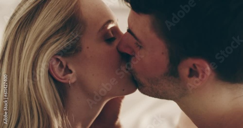 Couple, sexy kiss and closeup in home of young people sharing a romantic, intimate and erotic love. Bedroom, marriage and face of man, woman and kissing together for sensual romance, foreplay or lust