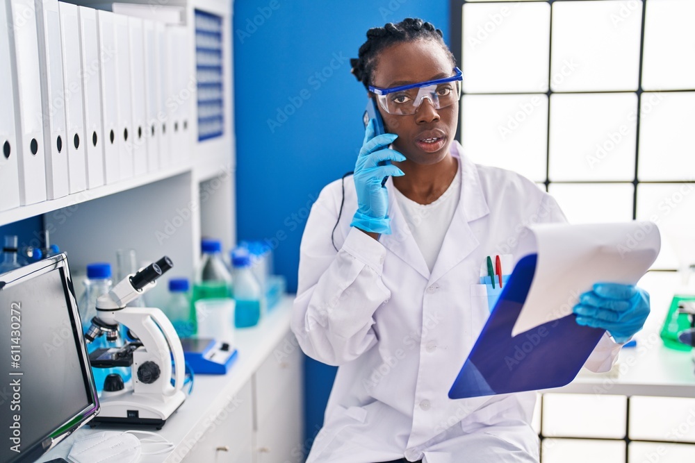 African american woman scientist reading document at laboratory African american woman scientist reading document at laboratory