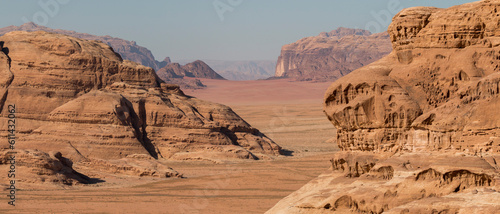 desert valley among rocky cliiffs, at the frontier of white and red desert, Wadi Rum Protected Area, Jordan photo