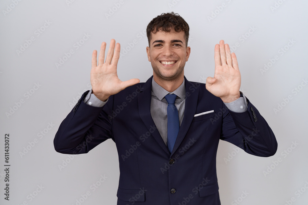 Young hispanic business man wearing suit and tie showing and pointing up with fingers number nine while smiling confident and happy. Young hispanic business man wearing suit and tie showing and pointing up with fingers number nine while smiling confident and happy.