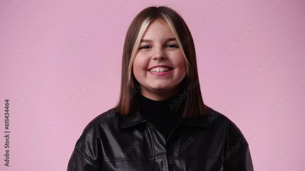 4k video of one girl who posing and smiling over pink background. 4k video of one girl who posing and smiling over pink background.