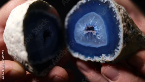 A caucasian man showing a blue agate mineral. photo