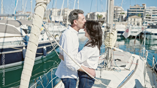 Senior man and woman couple hugging each other and kissing at boat