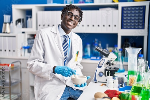 African american man scientist smiling confident mixing sample at laboratory