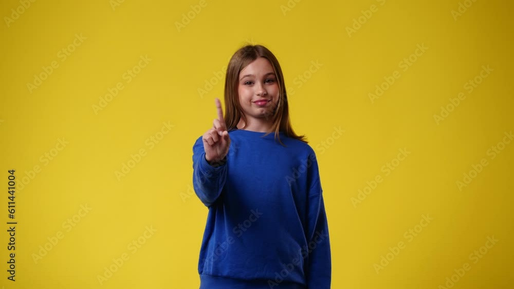 4k slow motion video of one girl who responds negatively over yellow background. 4k slow motion video of one girl who responds negatively over yellow background.