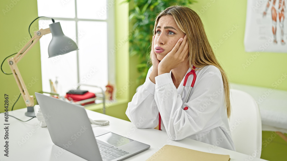 Young blonde woman doctor stressed working at clinic Young blonde woman doctor stressed working at clinic