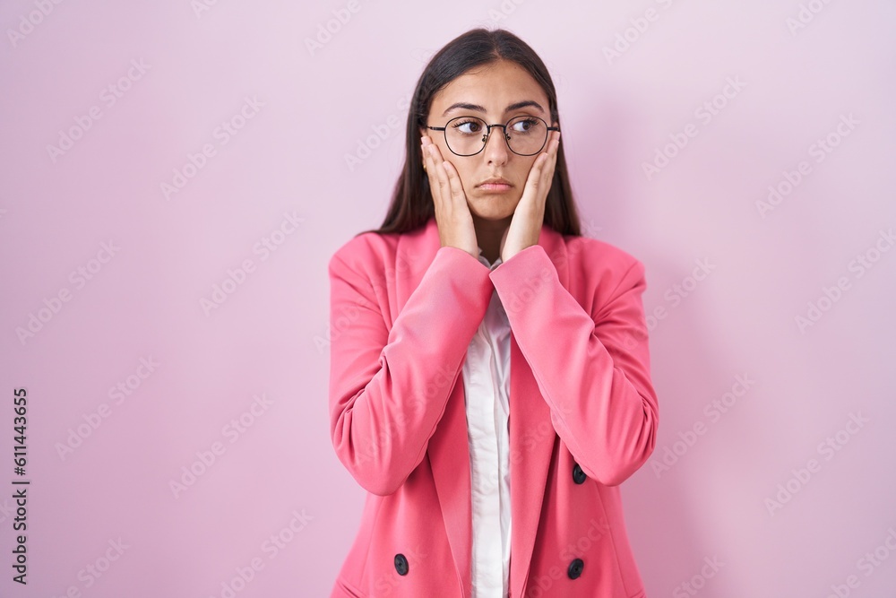 Young hispanic woman wearing business clothes and glasses tired hands covering face, depression and sadness, upset and irritated for problem Young hispanic woman wearing business clothes and glasses tired hands covering face, depression and sadness, upset and irritated for problem