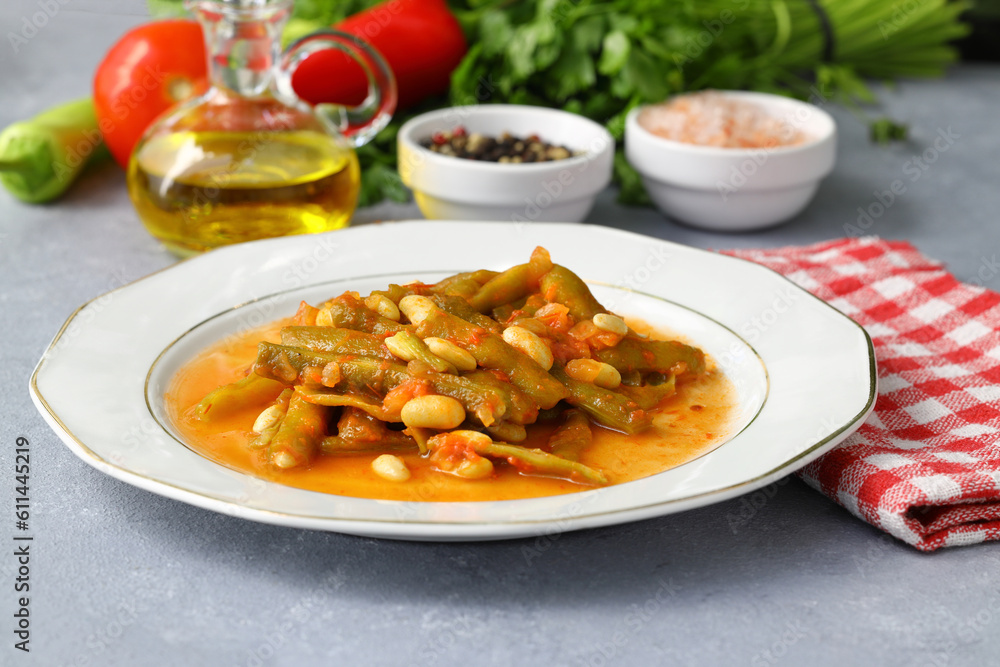 Homemade stewed green beans, tomatoes, garlic with olive oil. Zeytinyagli fasulye traditional food. Turkish cuisine. Homemade stewed green beans, tomatoes, garlic with olive oil. Zeytinyagli fasulye traditional food. Turkish cuisine.