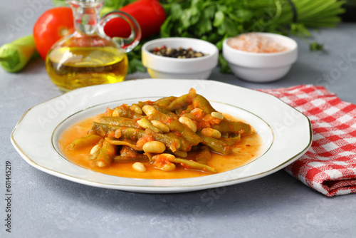 Homemade stewed green beans, tomatoes, garlic with olive oil. Zeytinyagli fasulye traditional food. Turkish cuisine.