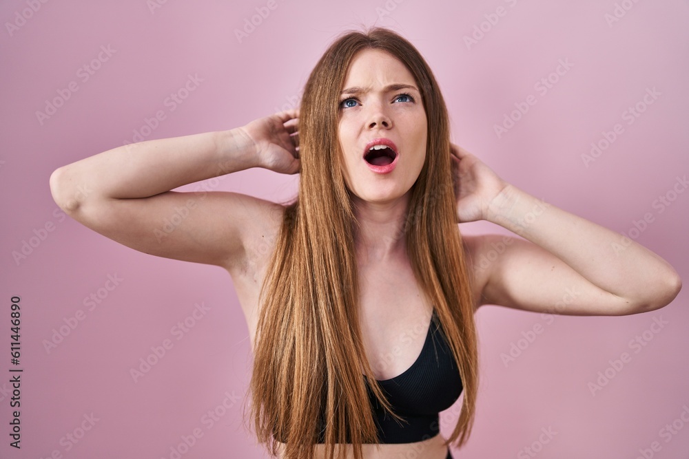 Young caucasian woman wearing lingerie over pink background angry and mad screaming frustrated and furious, shouting with anger looking up. Young caucasian woman wearing lingerie over pink background angry and mad screaming frustrated and furious, shouting with anger looking up.