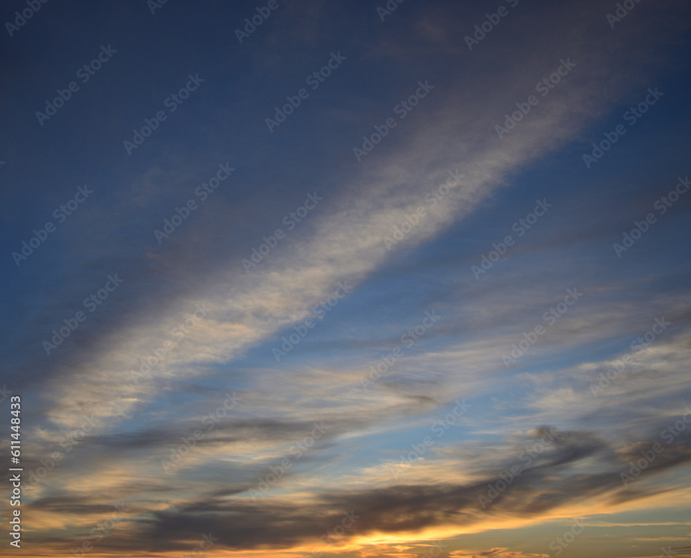 Beautiful sky at sunrise with scattered clouds and blue, white and yellow tones