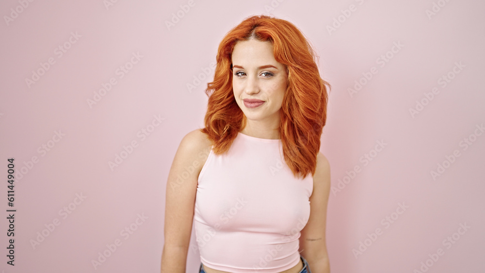 Young redhead woman smiling confident standing over isolated pink background Young redhead woman smiling confident standing over isolated pink background