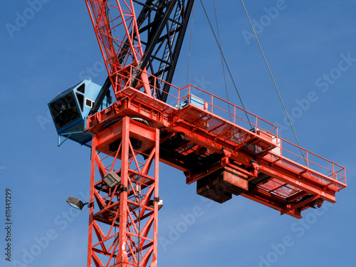 close up of the operator cabin and lifting machinery of a construction crane on a high rise building project