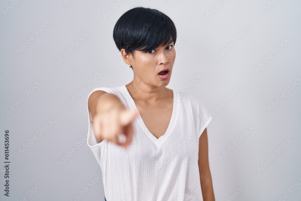 Young asian woman with short hair standing over isolated background pointing displeased and frustrated to the camera, angry and furious with you Young asian woman with short hair standing over isolated background pointing displeased and frustrated to the camera, angry and furious with you