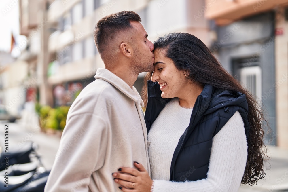 Man and woman couple hugging each other and kissing at street Man and woman couple hugging each other and kissing at street