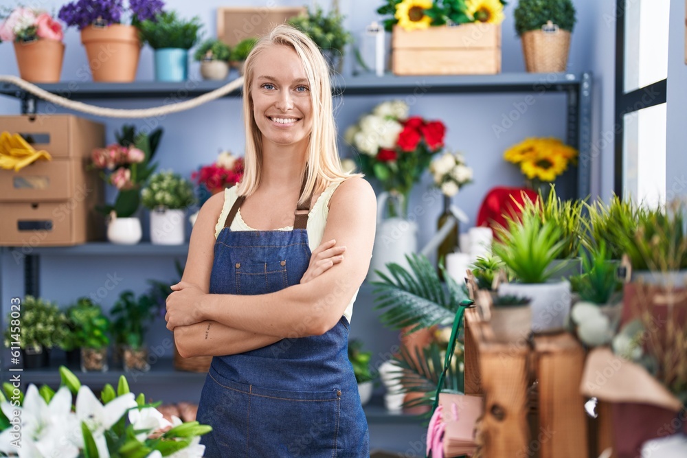 Young blonde woman florist smiling confident standing with arms crossed gesture at florist store