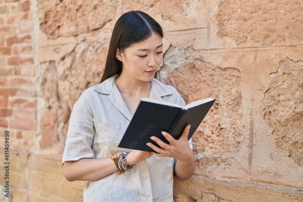 Chinese woman reading book at street Chinese woman reading book at street