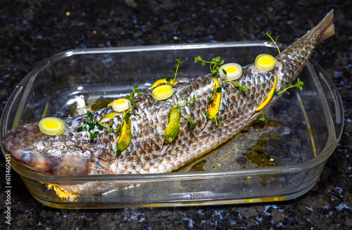 Traditional mullet fish ( Mugil cephalus, Chelon labrosus, Agonostomus monticola, Liza ramada or Mugil curema). Roasted tainha fish. photo