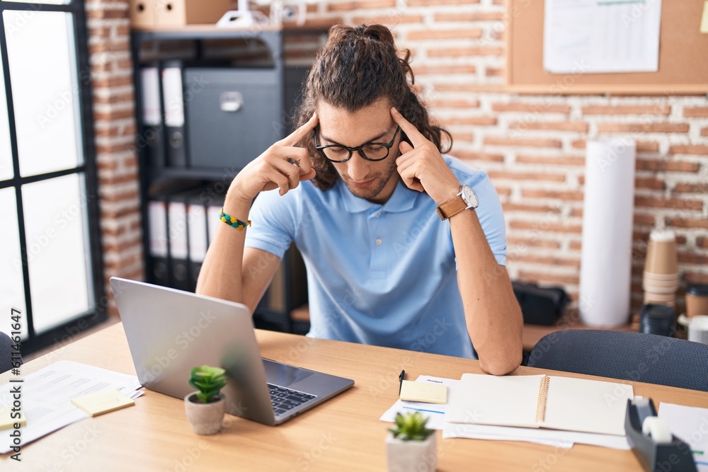 Young hispanic man business worker stressed using laptop at office Young hispanic man business worker stressed using laptop at office
