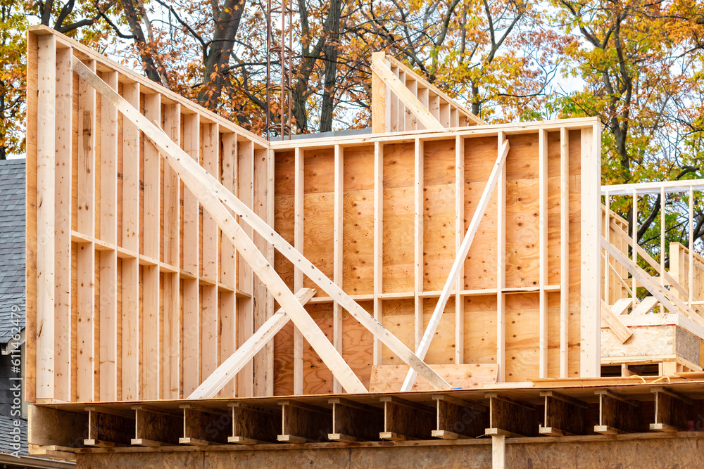 Frame construction lumber wall studs and sheathing with bracing on a