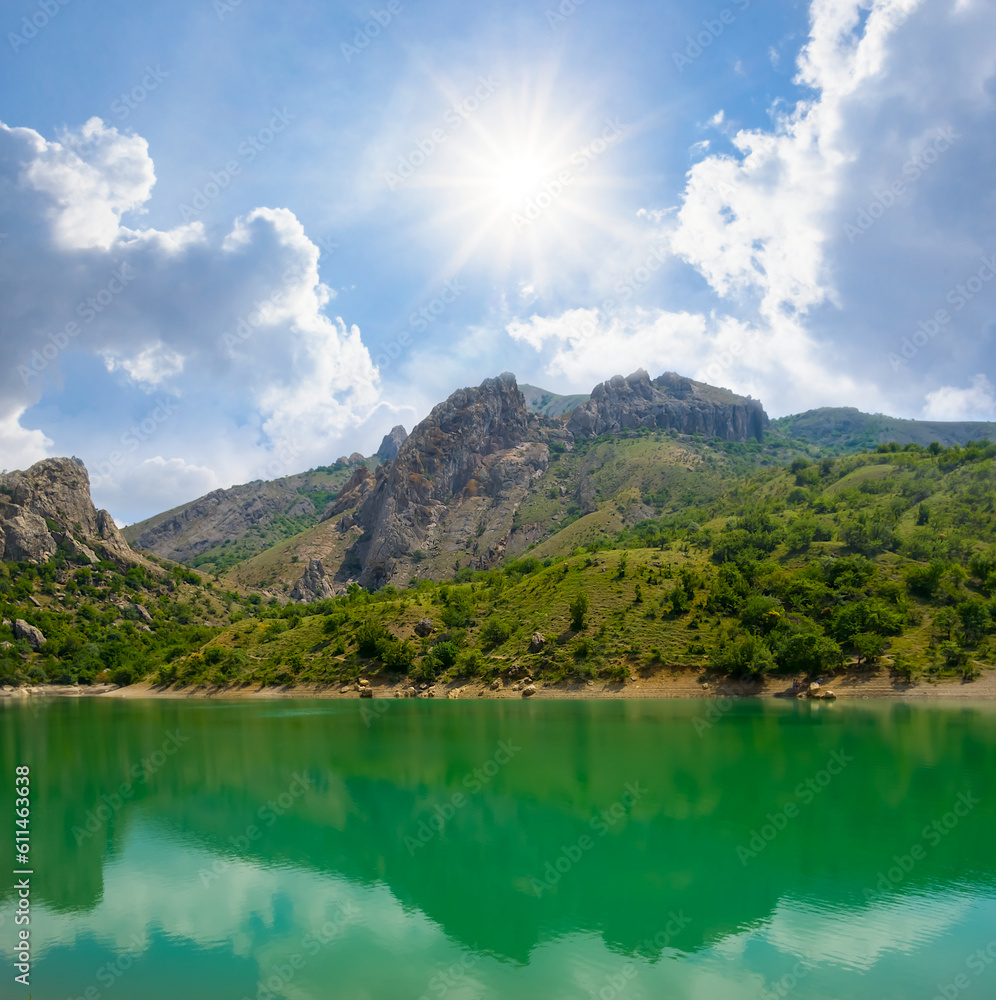 calm emerald lake in mountain at the sunny day calm emerald lake in mountain at the sunny day