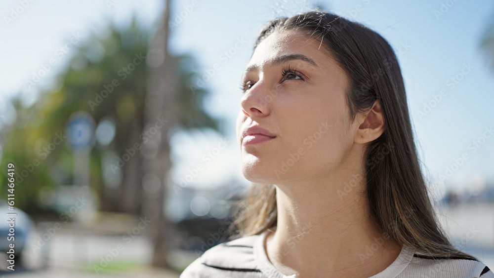 Young beautiful hispanic woman looking to the side with serious expression at street Young beautiful hispanic woman looking to the side with serious expression at street