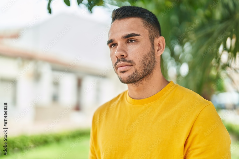 Young hispanic man looking to the side with serious expression at park Young hispanic man looking to the side with serious expression at park