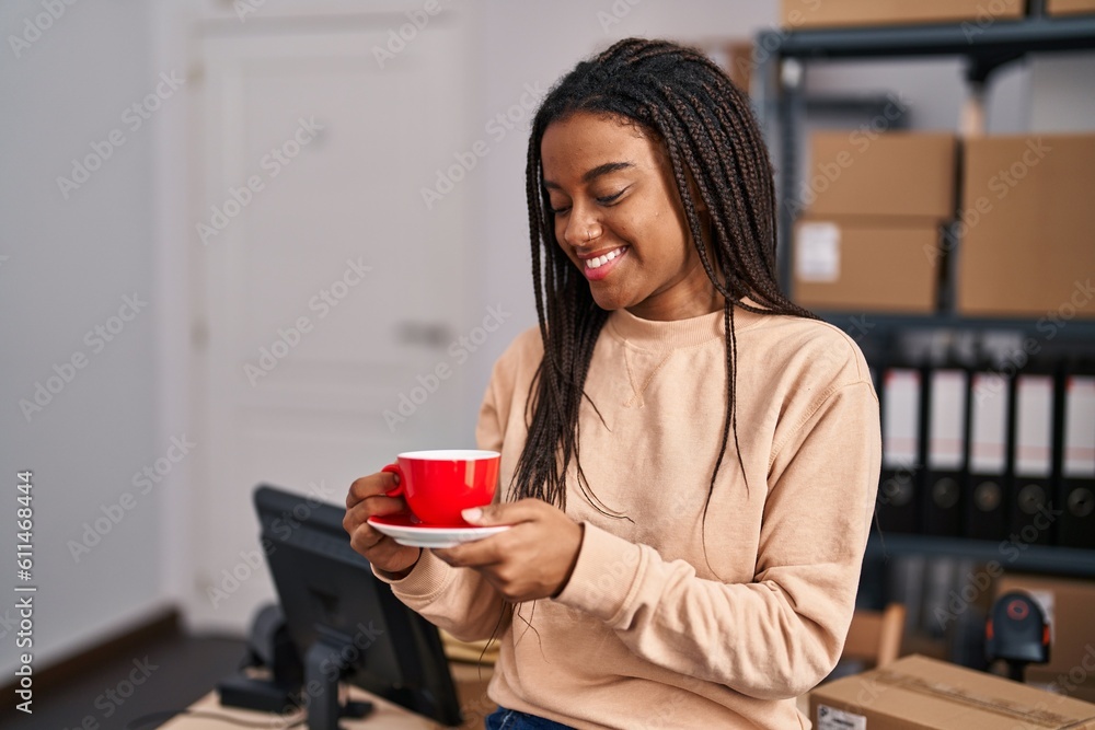 African american woman ecommerce business worker drinking coffee at office