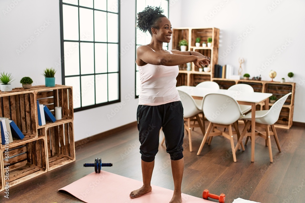 African american woman smiling confident stretching arms at home African american woman smiling confident stretching arms at home