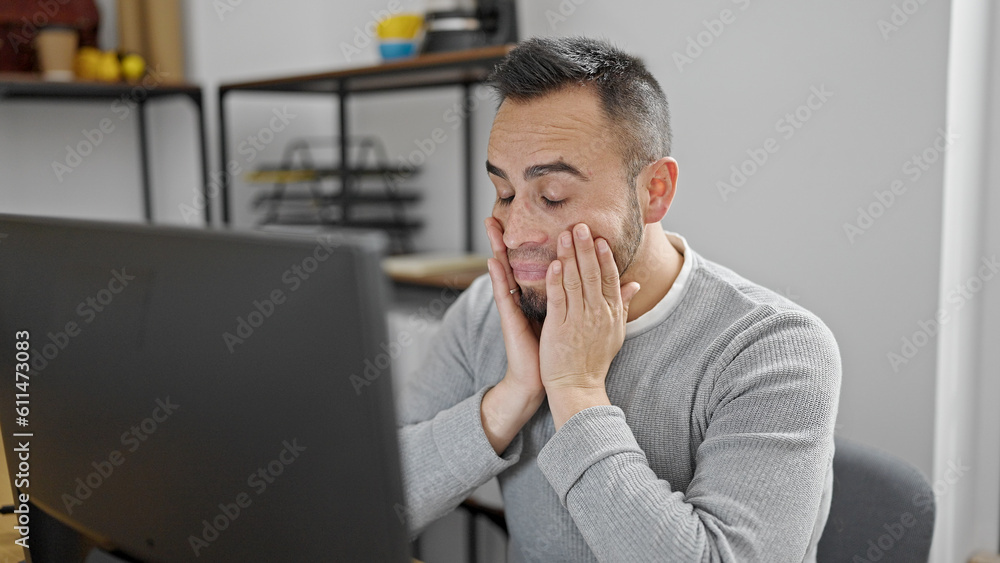 Hispanic man business worker stressed using computer at office Hispanic man business worker stressed using computer at office