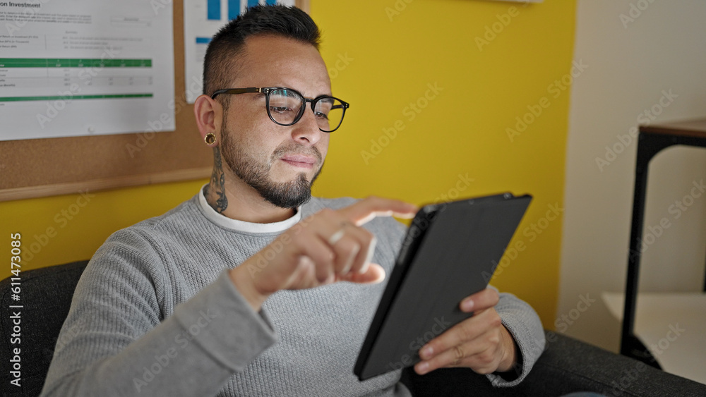 Hispanic man business worker using touchpad at office Hispanic man business worker using touchpad at office