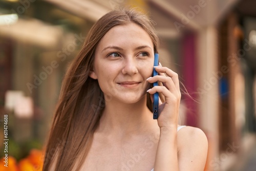 Young caucasian woman smiling confident talking on the smartphone at street