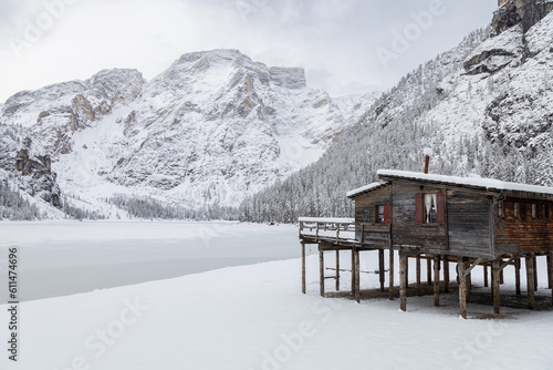 Obraz na plátně Wooden hut on stilts by the frozen Braies Lake surrounded by snowy mountains, Do