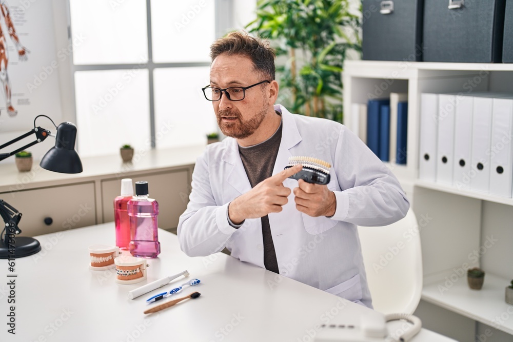 Young caucasian man dentist holding whitening test at clinic Young caucasian man dentist holding whitening test at clinic