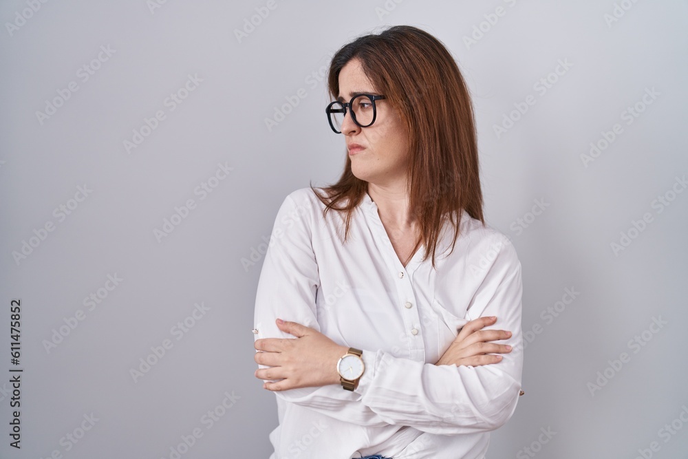 Brunette woman standing over white isolated background looking to the side with arms crossed convinced and confident Brunette woman standing over white isolated background looking to the side with arms crossed convinced and confident