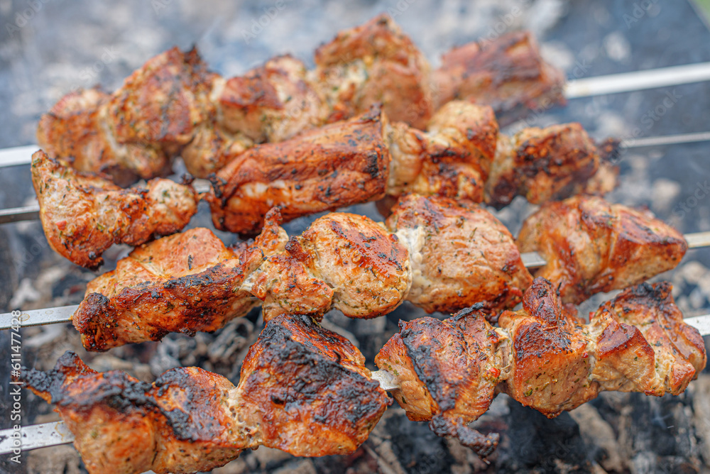 Pork skewers are cooked on the grill.