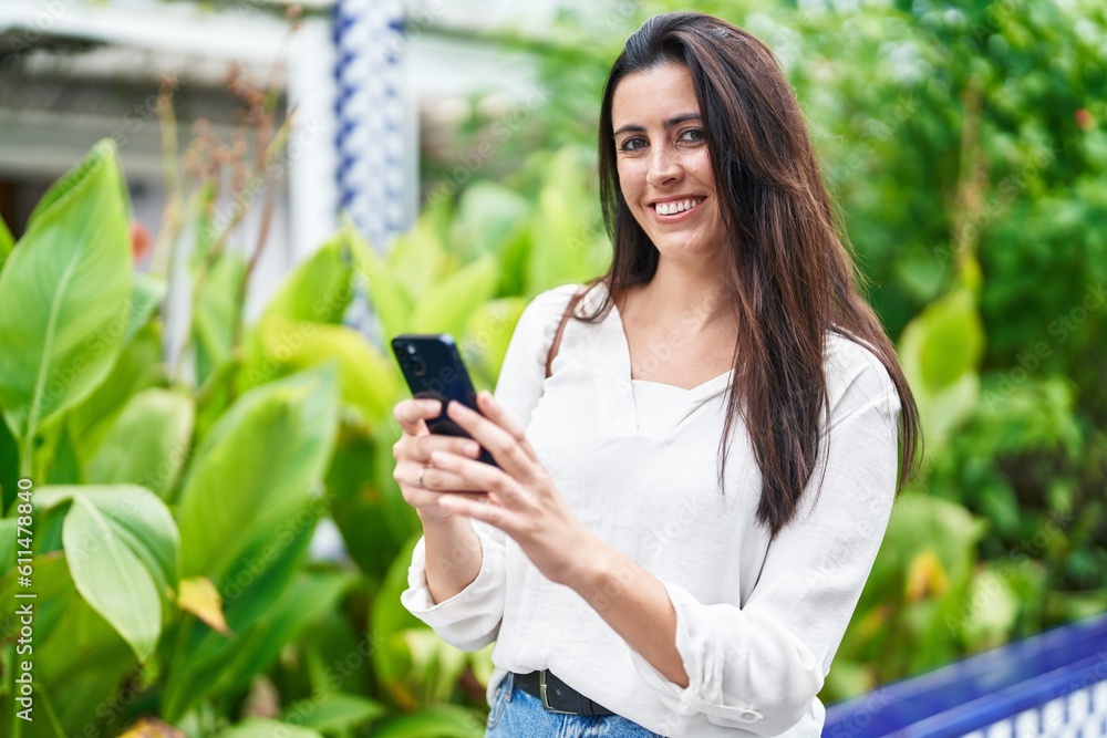 Young beautiful hispanic woman smiling confident using smartphone at park Young beautiful hispanic woman smiling confident using smartphone at park