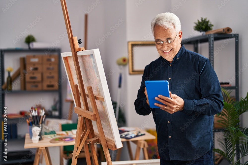 Senior man using touchpad drawing at art studio Senior man using touchpad drawing at art studio