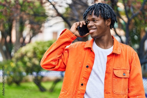 African american man smiling confident talking on the smartphone at park