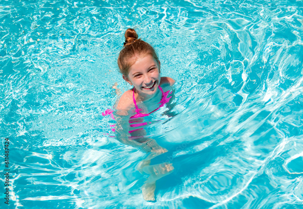 Portrait of lovely little teenage girl ressting on the edge of swimming pool and squinting her eyes because of the bright sun