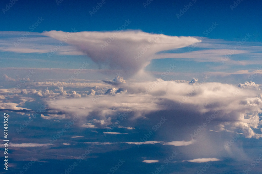 Obraz premium Aerial photograph of clouds outside of my airplane window on a cross country plane trip from Chicago to Los Angeles during the summer