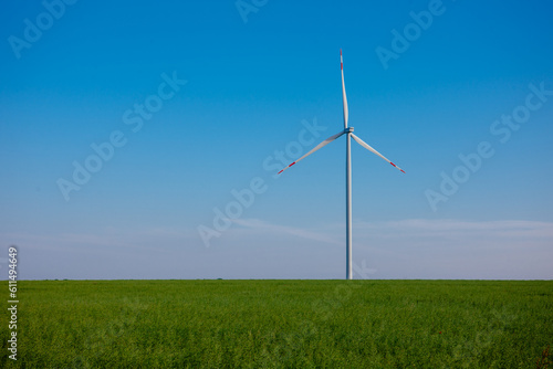 Panoramic view of wind farm or wind park, with high wind turbines for generation electricity with copy space. Green energy concept, in the world.