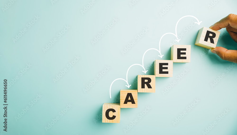 Hand meticulously positions a wooden cube block adorned with the word CAREER. This image symbolizes the opportunities, challenges, and growth associated with business success