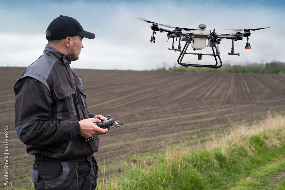 operator of an agricultural drone with a remote control, drone control for field spraying