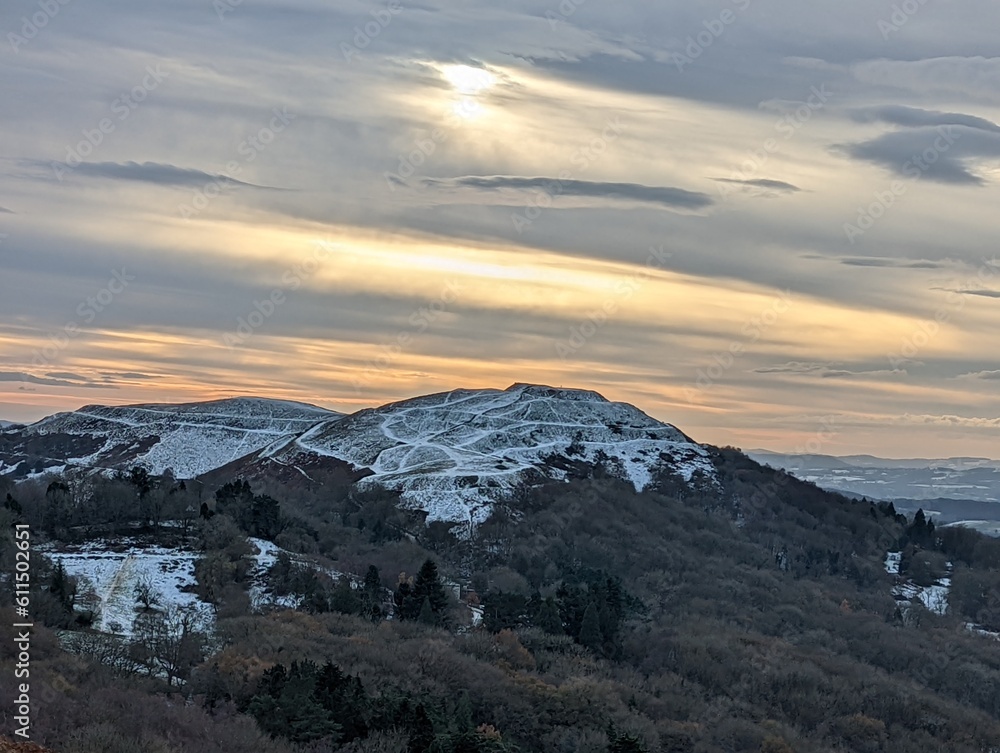 Malvern snow capped British hills amber sky