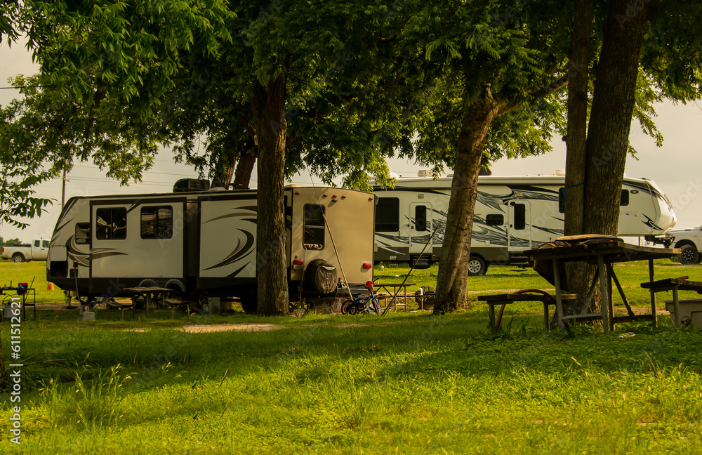 Rv trailers campsite under trees open field